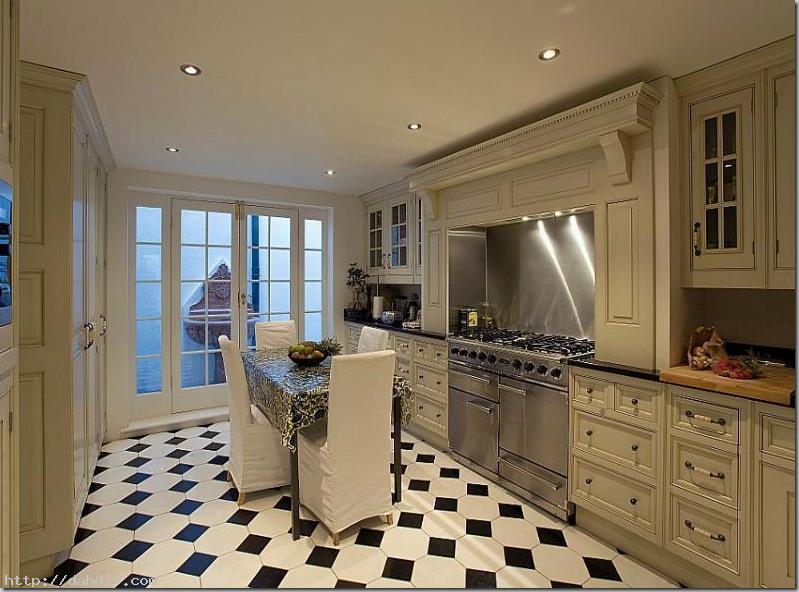black and white kitchen with light wood floor