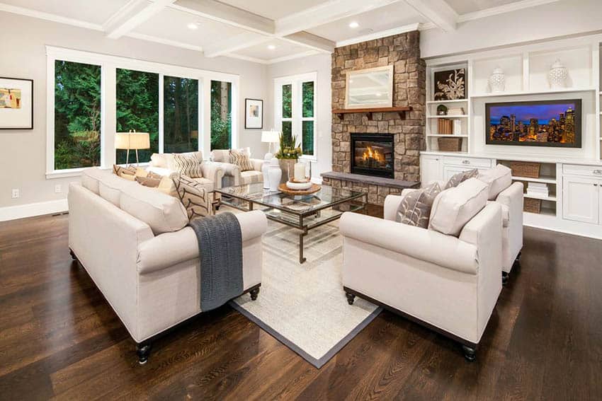 Living Room With Dark Hardwood Flooring Stone Fireplace And Box Ceiling